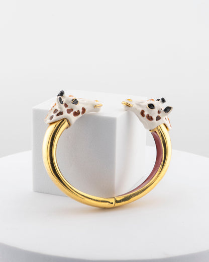 Open bracelet in white bronze with 18K gold plating and hand-painted giraffe heads.
An original Marri Cortona design — handmade in Tuscany.