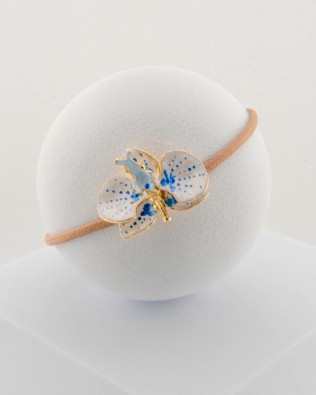 Handcrafted bracelet with adjustable cord and orchid pendant in 18K gold-plated bronze.
Each piece is hand-painted with enamel in Tuscany — unique and unrepeatable.