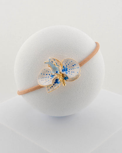 Handcrafted bracelet with adjustable cord and orchid pendant in 18K gold-plated bronze.
Each piece is hand-painted with enamel in Tuscany — unique and unrepeatable.