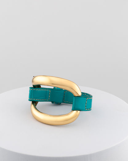 Handcrafted 18K gold-plated bronze bracelet with genuine crocodile leather strap.
An original Marri Cortona design — handmade in Tuscany.