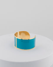 Handcrafted in Tuscany, the MarriCortona Smalto Bracelets in 18k gold and hand-painted enamel feature bold 30 mm bands — radiant, elegant, and uniquely Italian.