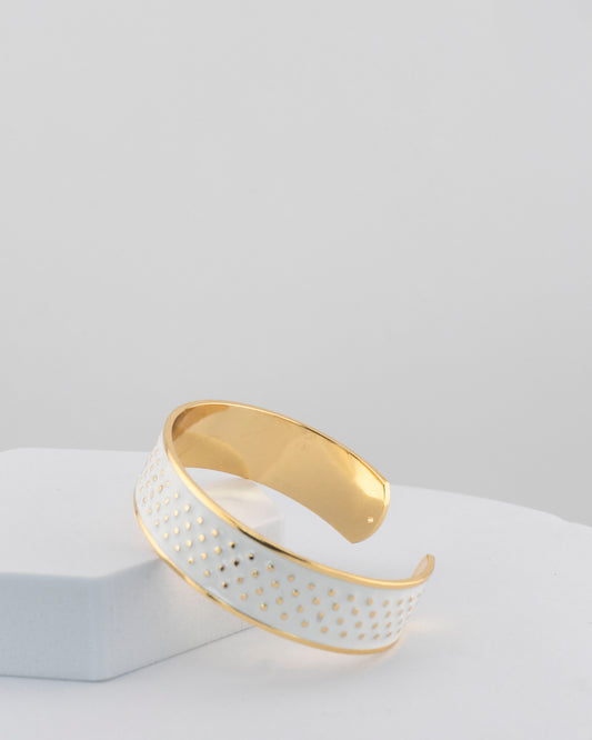Adjustable bangle in 18K gold-plated bronze with black & white enamel.
Handcrafted in Tuscany — bold lines, timeless elegance.