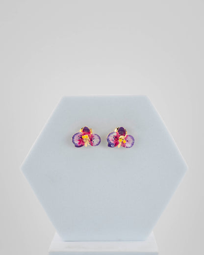 Handcrafted in Tuscany, the Marri Cortona Orchidea Earrings in 18k gold bronze are hand-enameled jewels that blend light, artistry, and timeless elegance.