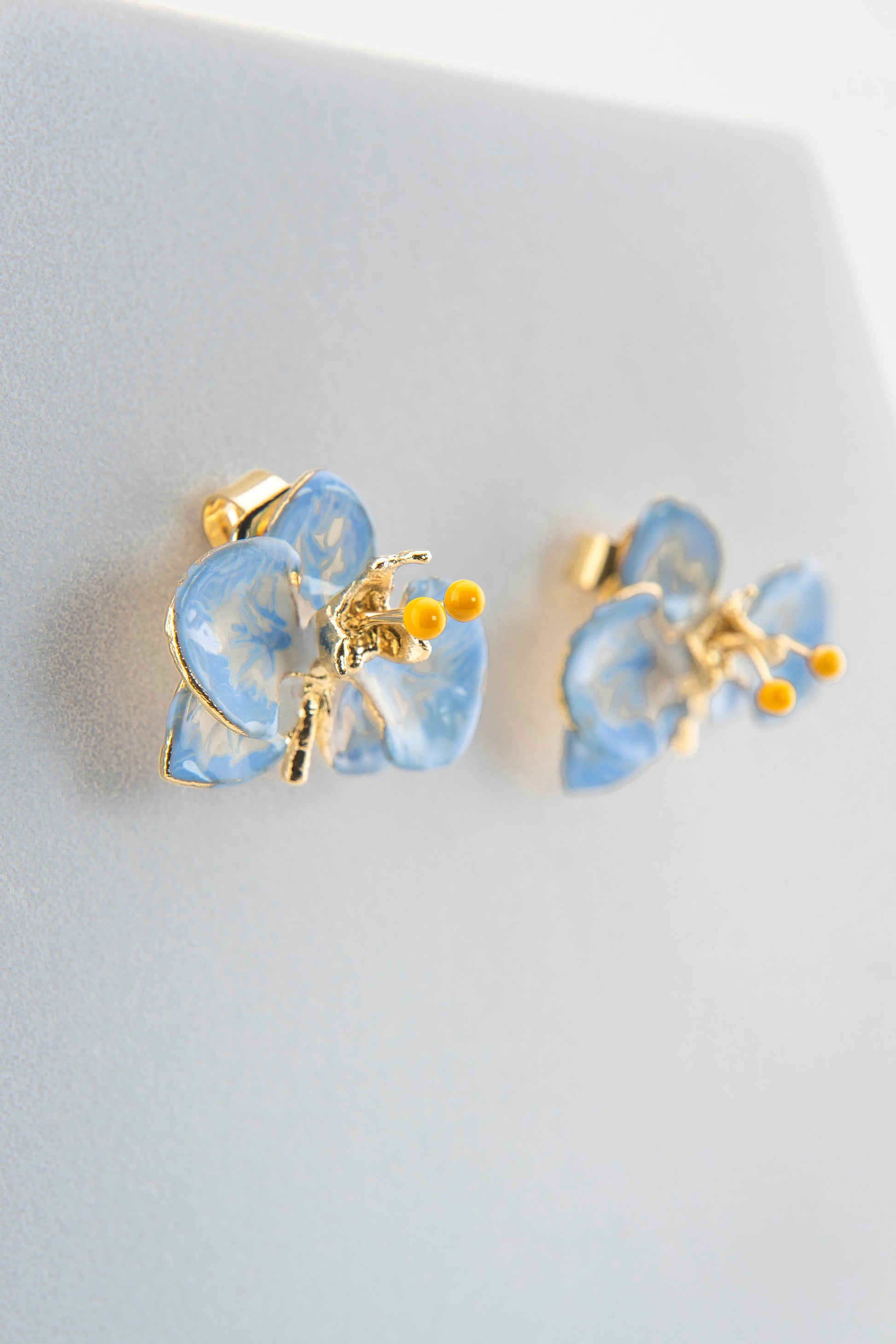 Handcrafted in Tuscany, the Marri Cortona Orchidea Earrings in 18k gold bronze are hand-enameled jewels that blend light, artistry, and timeless elegance.