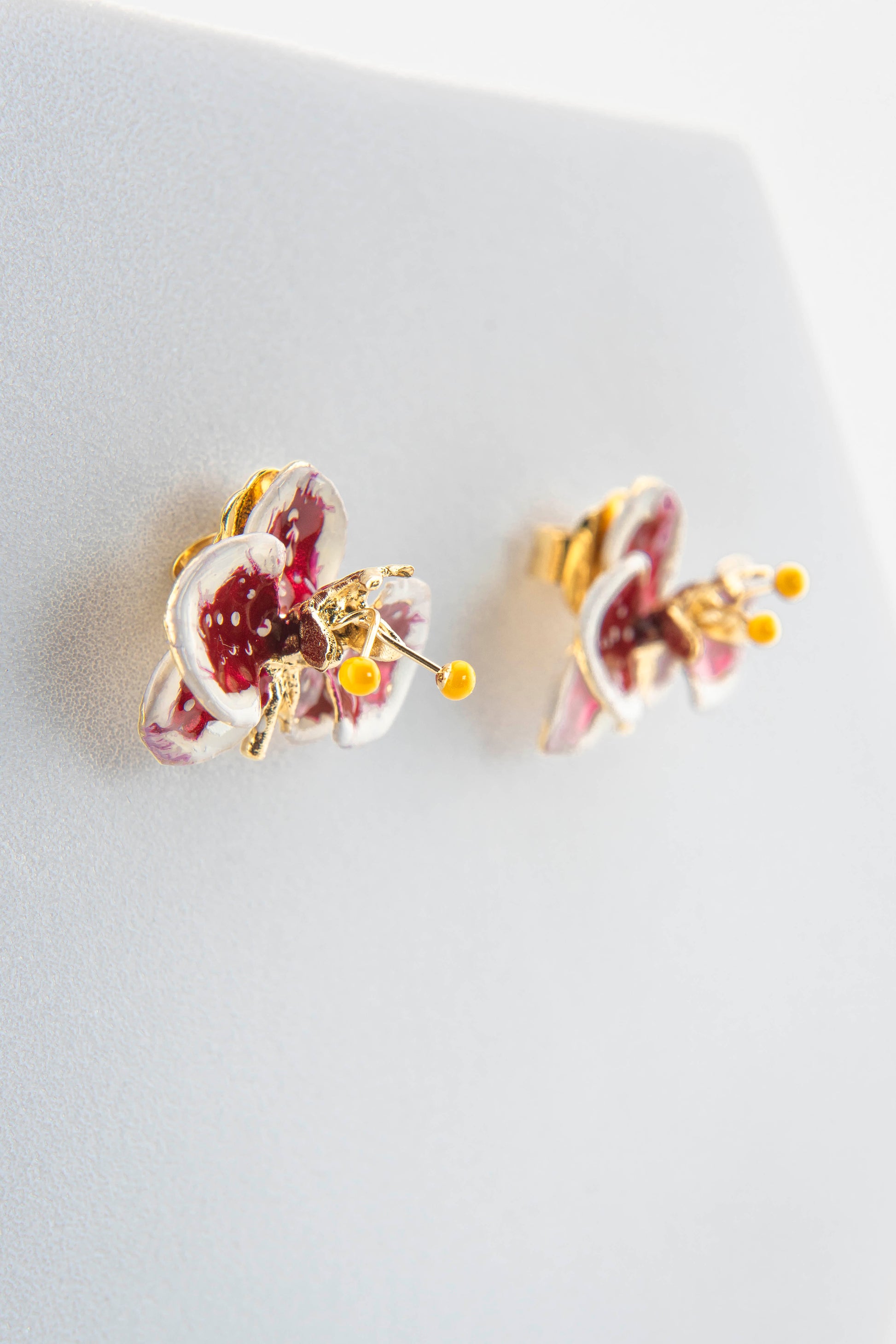 Handcrafted in Tuscany, the Marri Cortona Orchidea Earrings in 18k gold bronze are hand-enameled jewels that blend light, artistry, and timeless elegance.