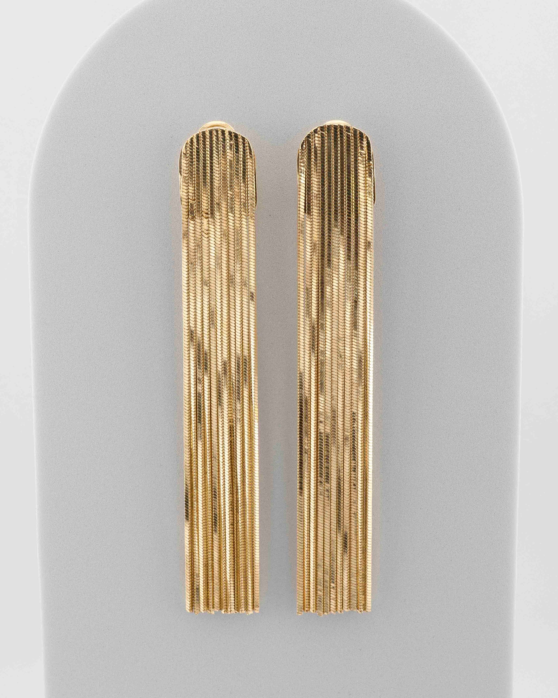 Handcrafted in Tuscany, the MarriCortona Voilà Earrings in bronze 18k gold plated feature 10 cm golden fringes — luminous, elegant, and timelessly Italian.