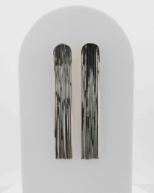 Handcrafted in Tuscany, the MarriCortona Voilà Earrings in bronze 18k blak gold plated feature 10 cm golden fringes — luminous, elegant, and timelessly Italian.