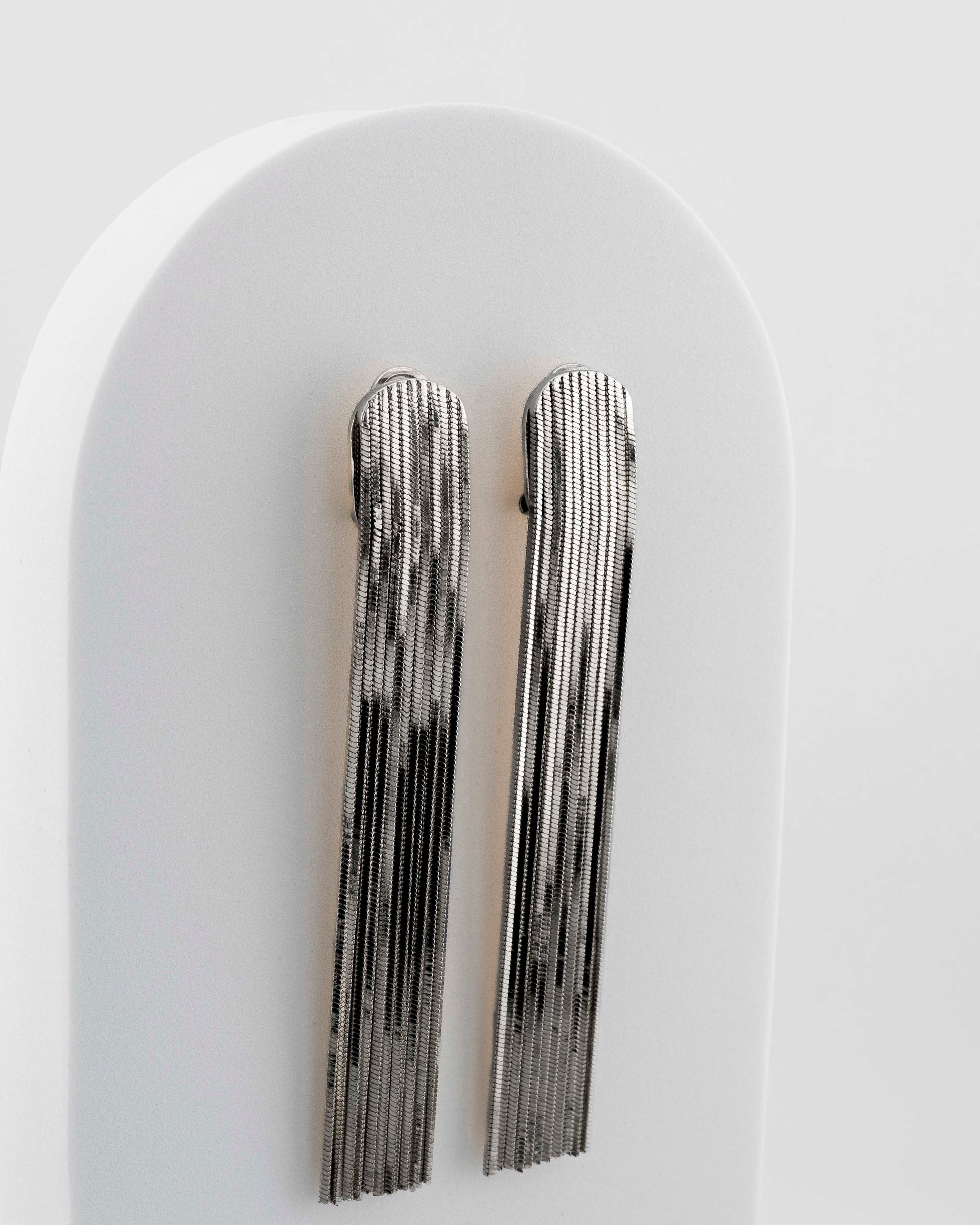 Handcrafted in Tuscany, the MarriCortona Voilà Earrings in bronze 18k blak gold plated feature 10 cm golden fringes — luminous, elegant, and timelessly Italian.