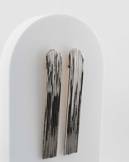 Handcrafted in Tuscany, the MarriCortona Voilà Earrings in bronze 18k blak gold plated feature 10 cm golden fringes — luminous, elegant, and timelessly Italian.