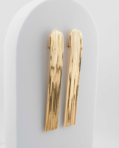 Handcrafted in Tuscany, the MarriCortona Voilà Earrings in bronze 18k gold plated feature 10 cm golden fringes — luminous, elegant, and timelessly Italian.