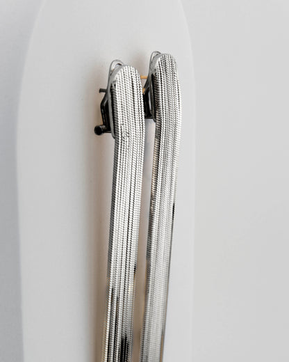 Handcrafted in Tuscany, the MarriCortona Voilà Earrings in bronze 18k blak gold plated feature 10 cm golden fringes — luminous, elegant, and timelessly Italian.