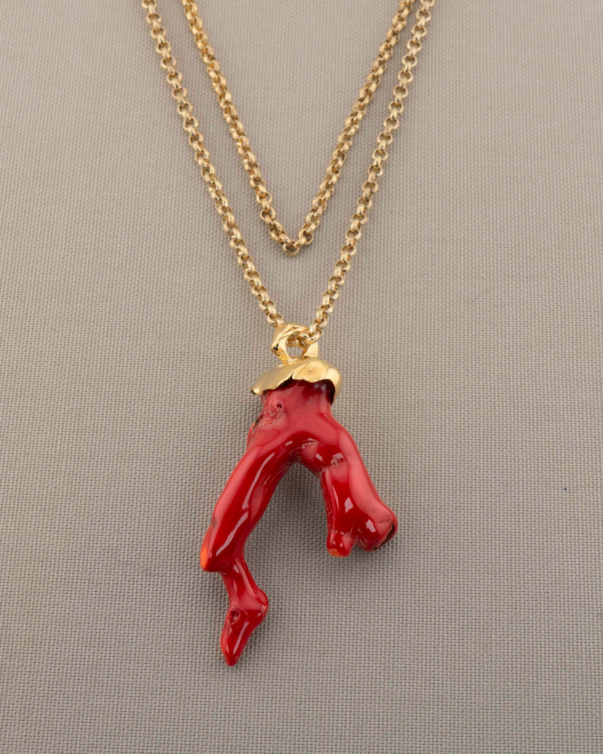 A handcrafted necklace in 18K gold-plated bronze featuring a coral-inspired pendant.
Designed by Marri Cortona and handmade in Tuscany with timeless elegance.