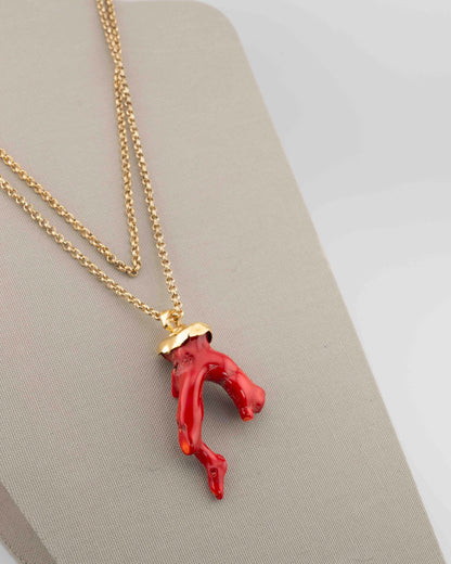 A handcrafted necklace in 18K gold-plated bronze featuring a coral-inspired pendant.
Designed by Marri Cortona and handmade in Tuscany with timeless elegance.