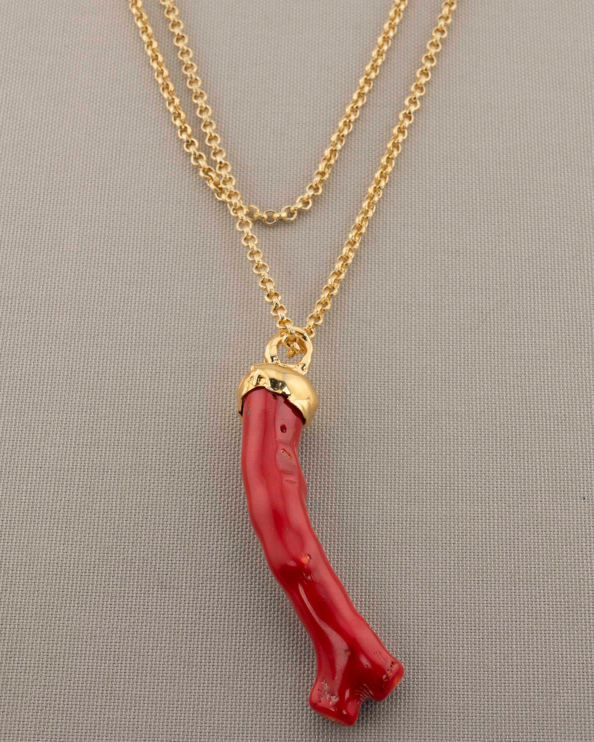 A handcrafted necklace in 18K gold-plated bronze featuring a coral-inspired pendant.
Designed by Marri Cortona and handmade in Tuscany with timeless elegance.