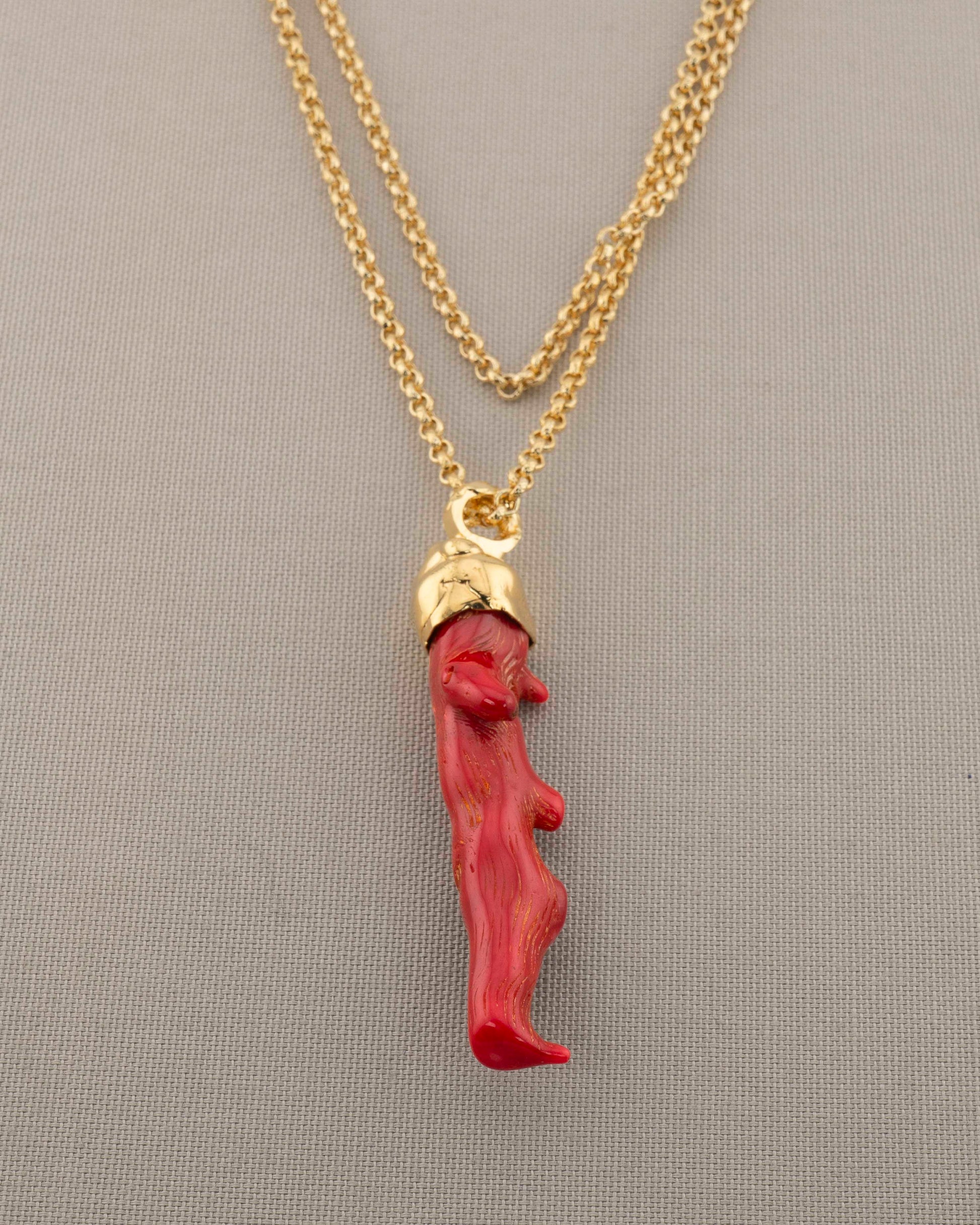 A handcrafted necklace in 18K gold-plated bronze featuring a coral-inspired pendant.
Designed by Marri Cortona and handmade in Tuscany with timeless elegance.
