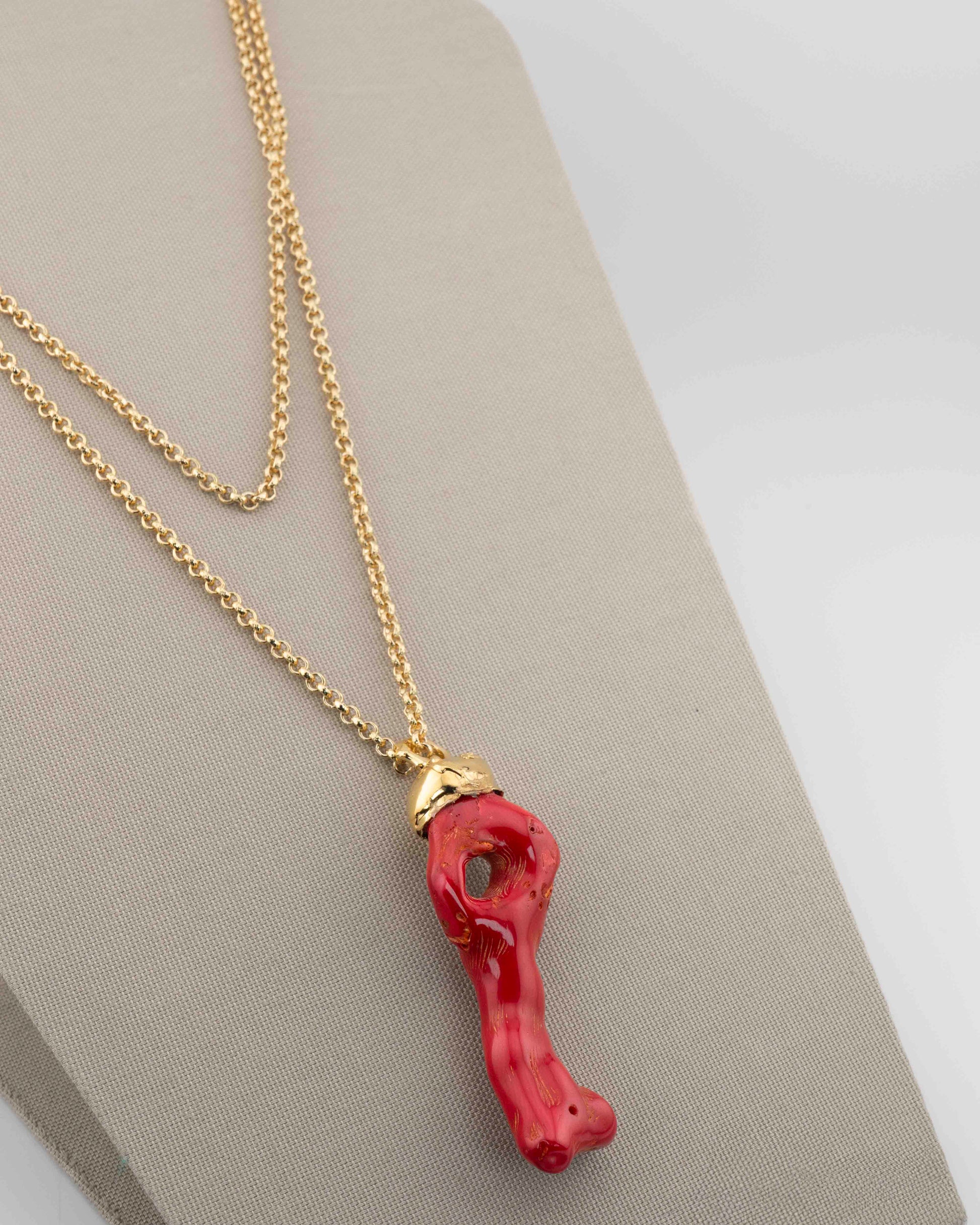 A handcrafted necklace in 18K gold-plated bronze featuring a coral-inspired pendant.
Designed by Marri Cortona and handmade in Tuscany with timeless elegance.