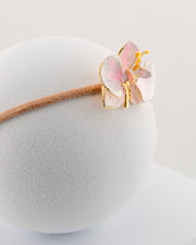 Handcrafted bracelet with adjustable cord and orchid pendant in 18K gold-plated bronze.
Each piece is hand-painted with enamel in Tuscany — unique and unrepeatable.