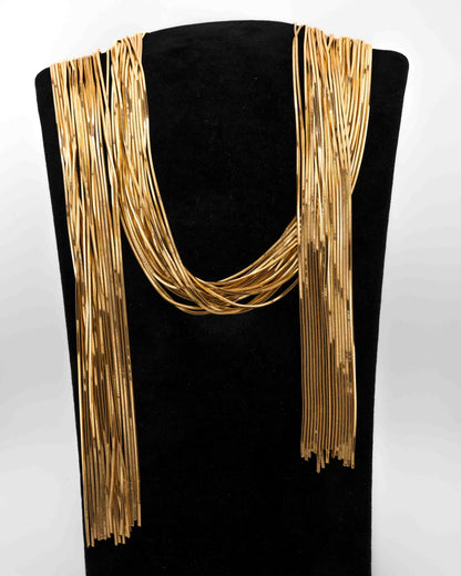 Handcrafted in Tuscany, the MarriCortona Voilà Necklace in 18k gold bronze features 23 luminous strands — a versatile icon of modern Italian elegance.