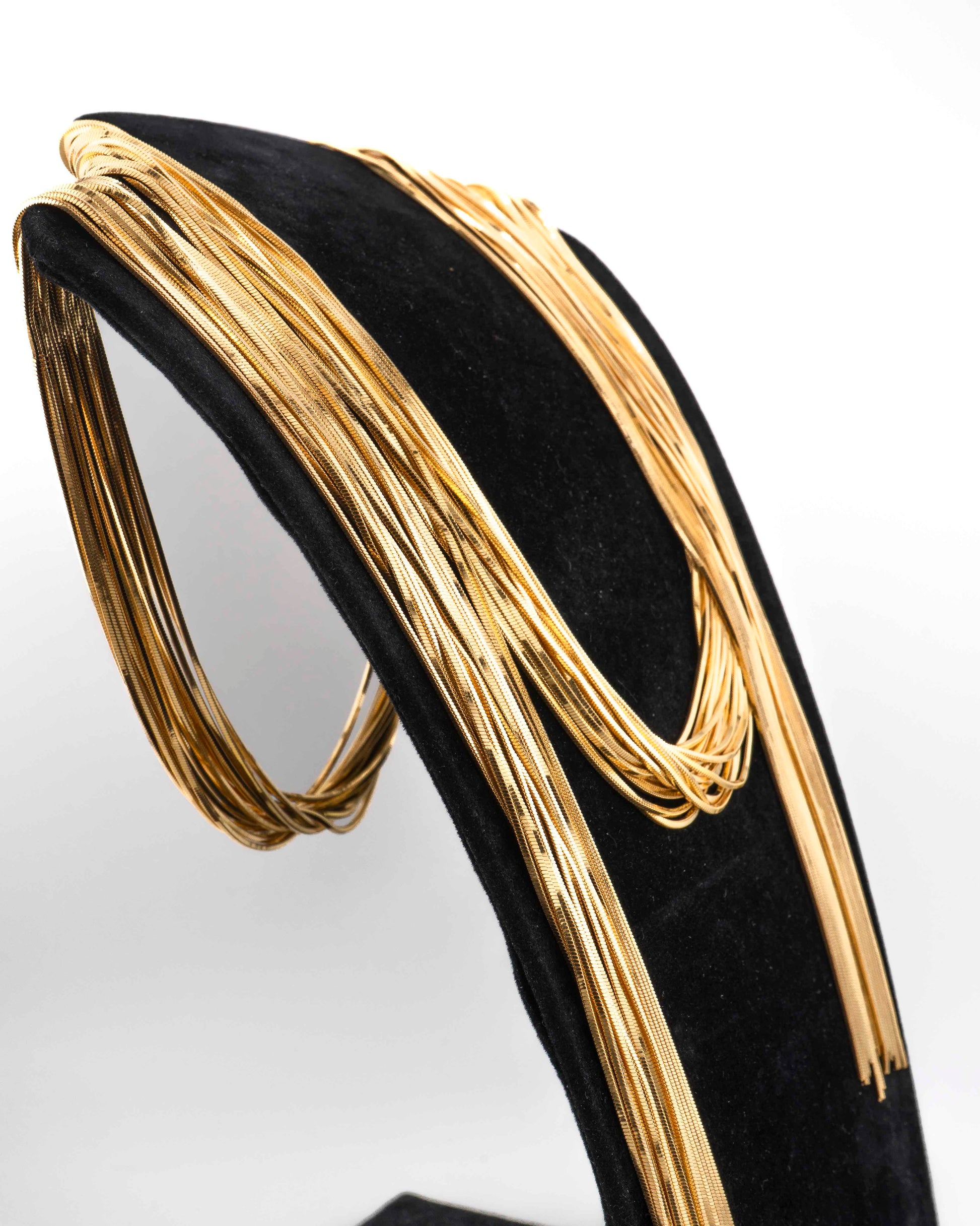 Handcrafted in Tuscany, the MarriCortona Voilà Necklace in bronze18k gold plated features 18 luminous strands — a versatile icon of modern Italian elegance.