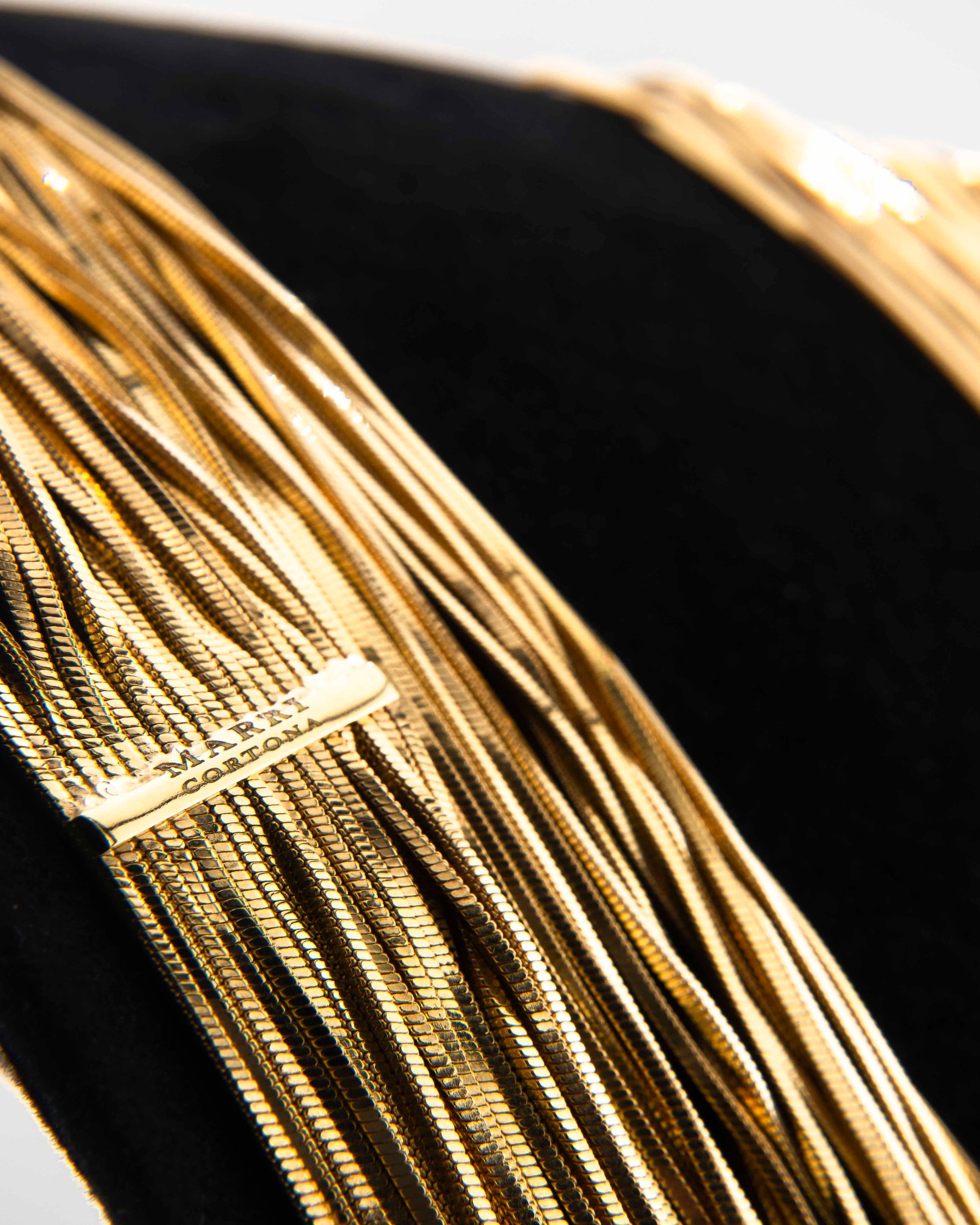 Handcrafted in Tuscany, the MarriCortona Voilà Necklace in 18k gold bronze features 23 luminous strands — a versatile icon of modern Italian elegance.