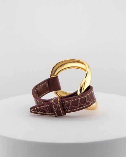 Handcrafted 18K gold-plated bronze bracelet with genuine crocodile leather strap.
An original Marri Cortona design — handmade in Tuscany.