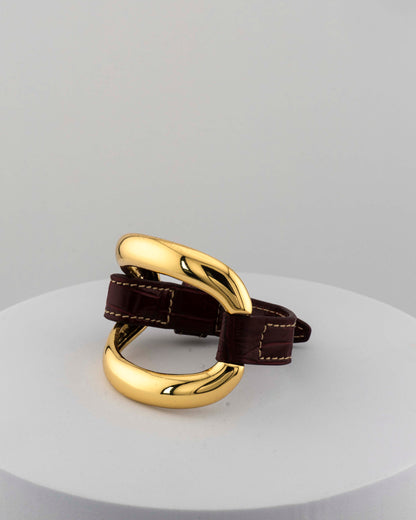 Handcrafted 18K gold-plated bronze bracelet with genuine crocodile leather strap.
An original Marri Cortona design — handmade in Tuscany.
