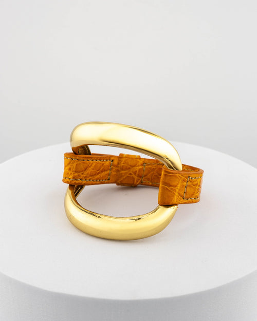 Handcrafted 18K gold-plated bronze bracelet with genuine crocodile leather strap.
An original Marri Cortona design — handmade in Tuscany.