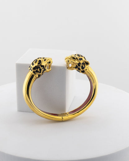 Open bracelet in white bronze with 18K gold plating and hand-painted panther heads.
An original Marri Cortona design — handmade in Tuscany.