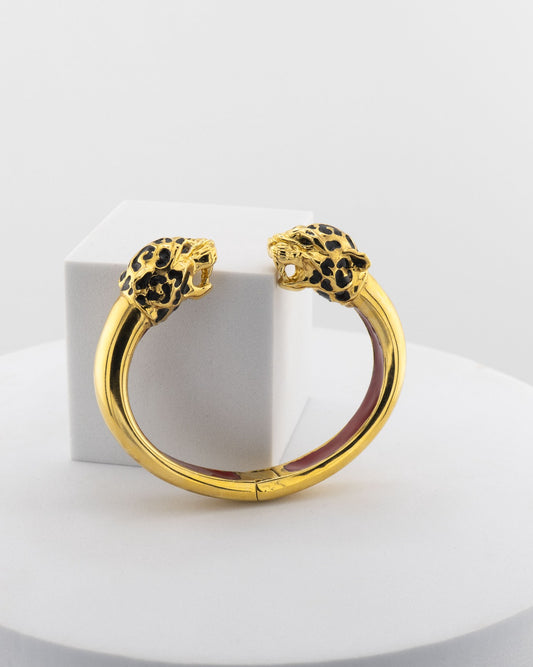 Open bracelet in white bronze with 18K gold plating and hand-painted panther heads.
An original Marri Cortona design — handmade in Tuscany.