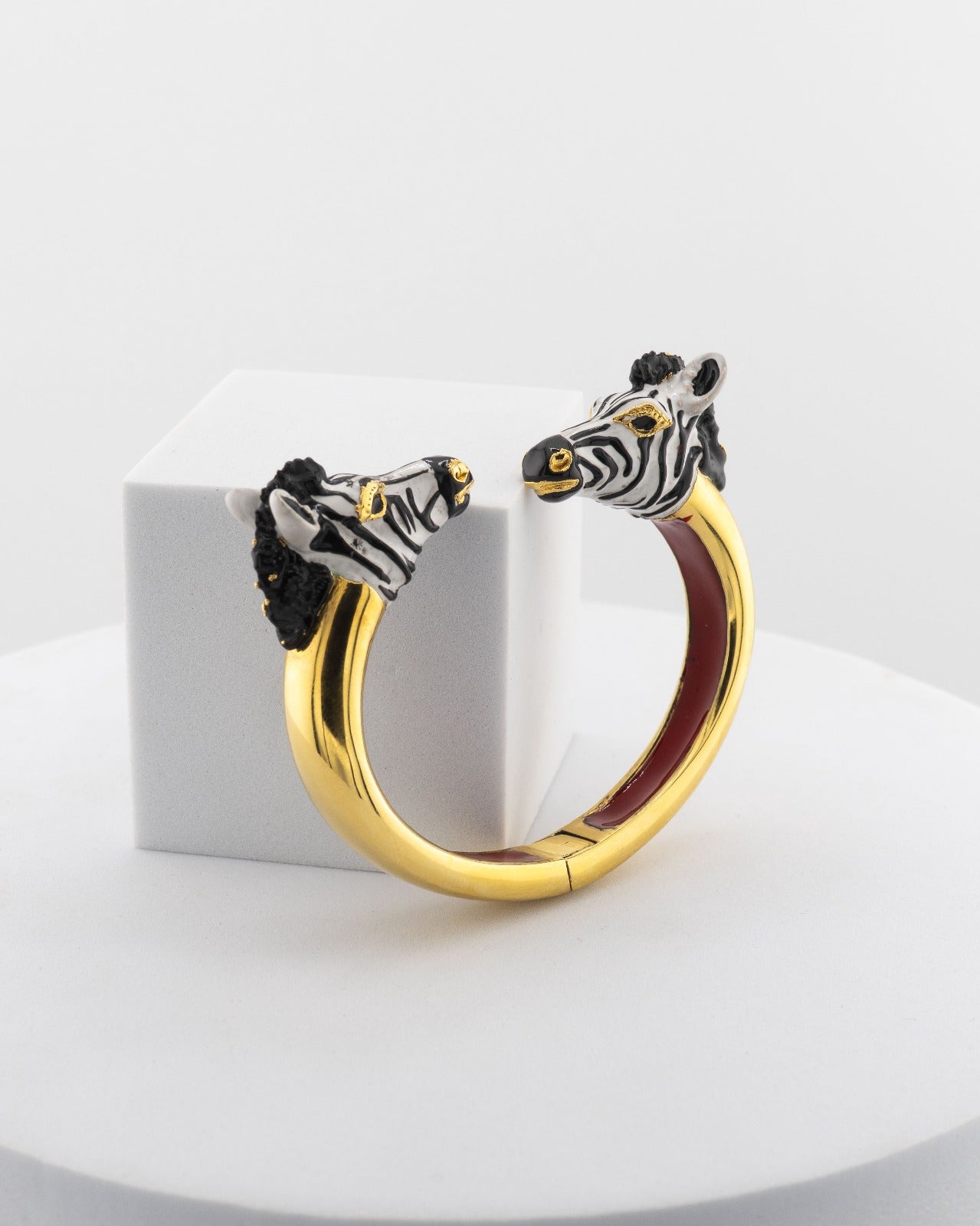 Open bracelet in white bronze with 18K gold plating, featuring hand-painted zebra heads.
An original Marri Cortona design — handmade in Tuscany.