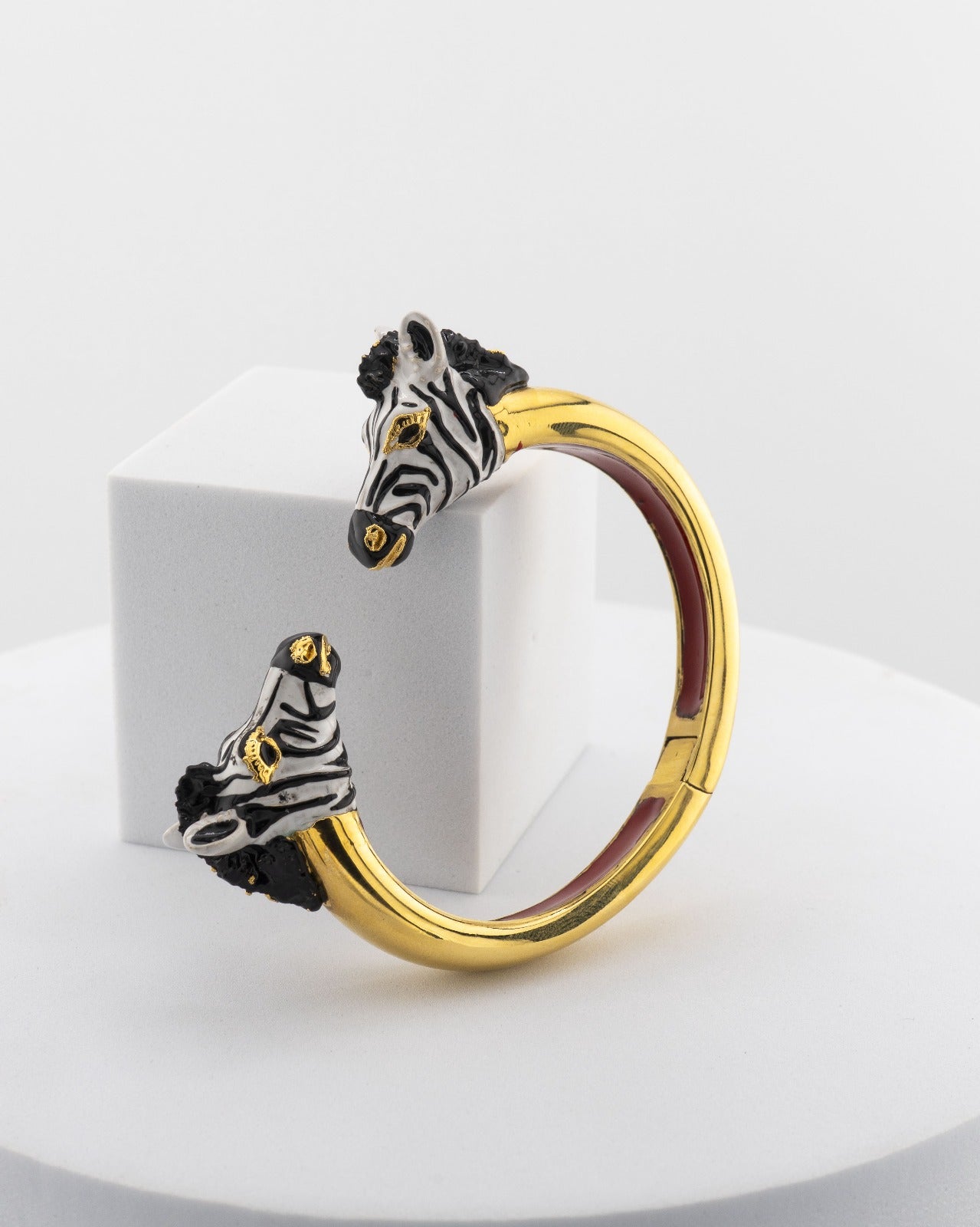 Open bracelet in white bronze with 18K gold plating, featuring hand-painted zebra heads.
An original Marri Cortona design — handmade in Tuscany.