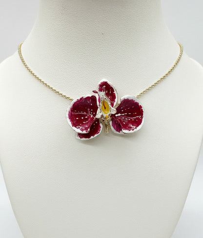 Handcrafted in Tuscany, the Marri Cortona Orchidea Necklace in 18k gold bronze captures the orchid’s grace — elegant, hand-enameled, and timelessly Italian.