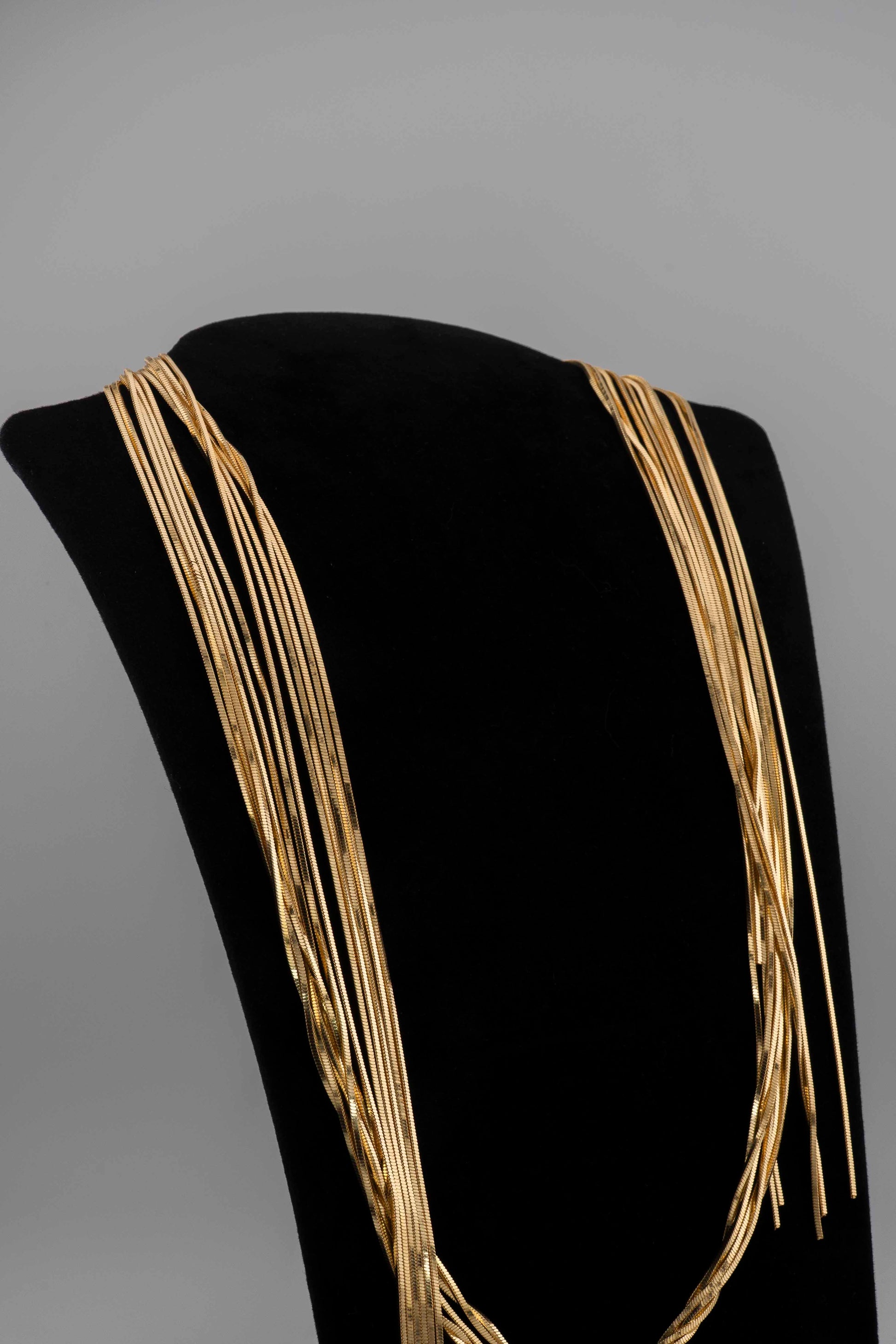 Handcrafted in Tuscany, the MarriCortona Voilà Necklace in bronze18k gold plated features 6 luminous strands — a versatile icon of modern Italian elegance.