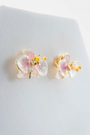 Handcrafted in Tuscany, the Marri Cortona Orchidea Earrings in 18k gold bronze are hand-enameled jewels that blend light, artistry, and timeless elegance.