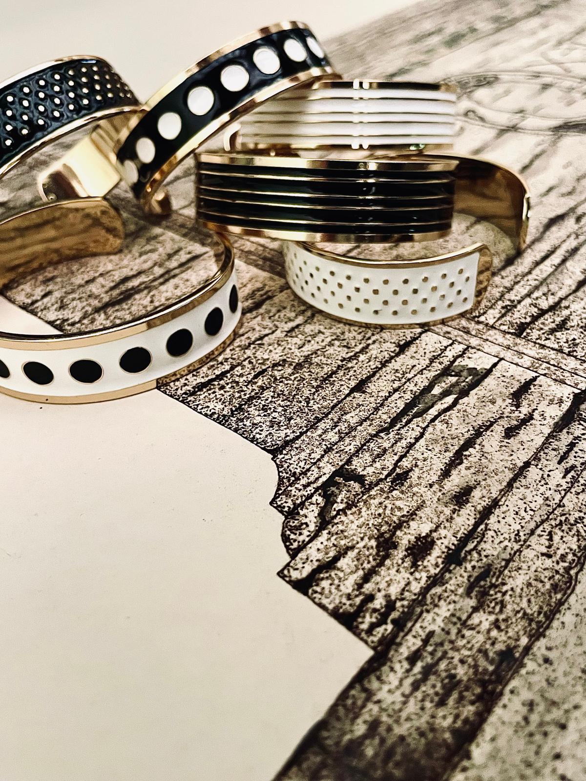 Adjustable bangle in 18K gold-plated bronze with black & white enamel.
Handcrafted in Tuscany — bold lines, timeless elegance.